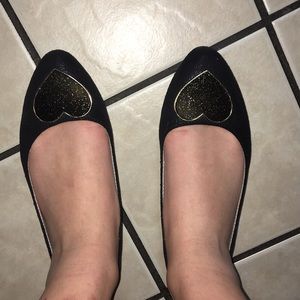 Pointy black flats, black and gold heart detail.